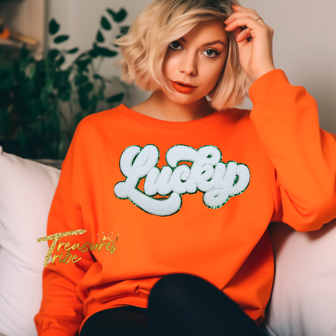 Lucky White Chenille Patch on an orange sweatshirt front side