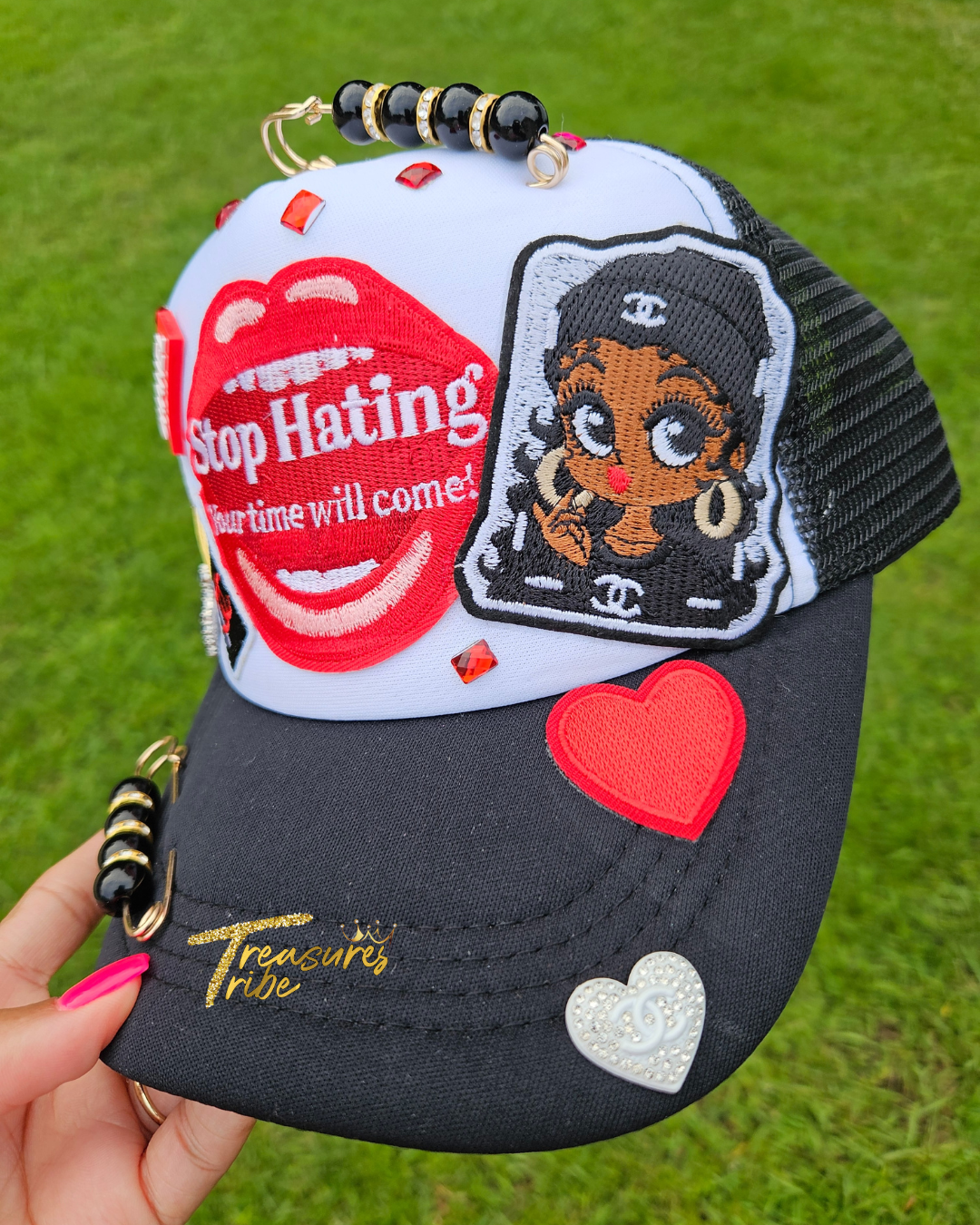 Black and white cap with cartoon character and text on a grass background