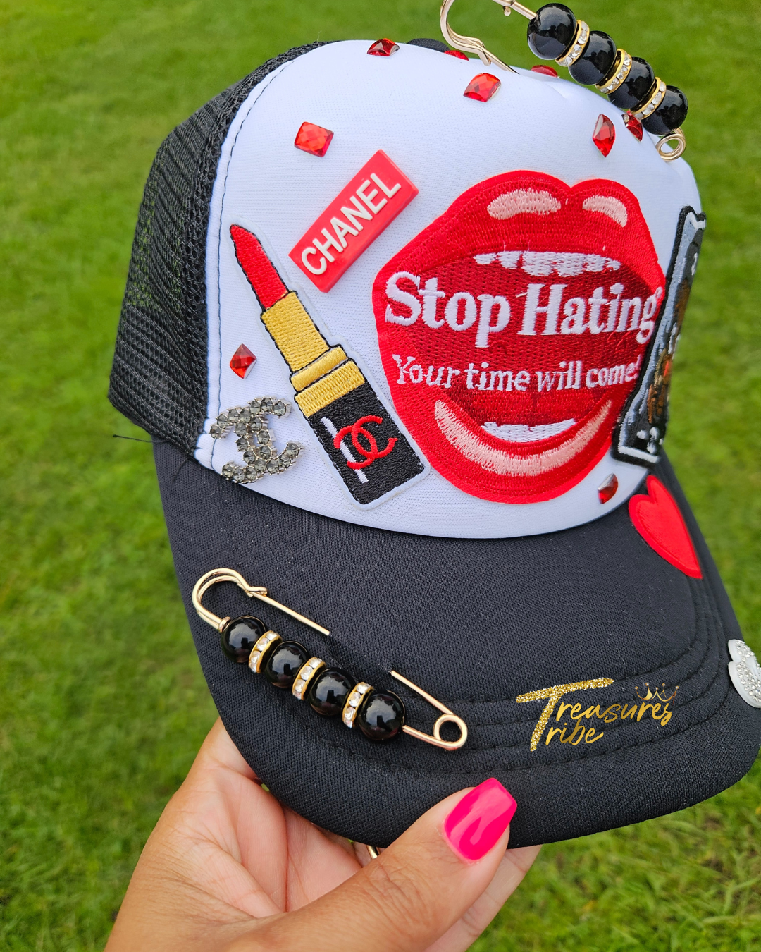 Black and white cap with red text and graphics on a grass background