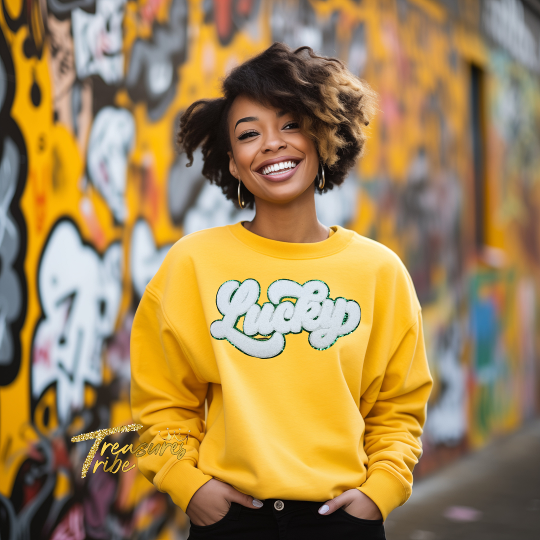 Lucky White Chenille Patch on a Gold Sweatshirt front side