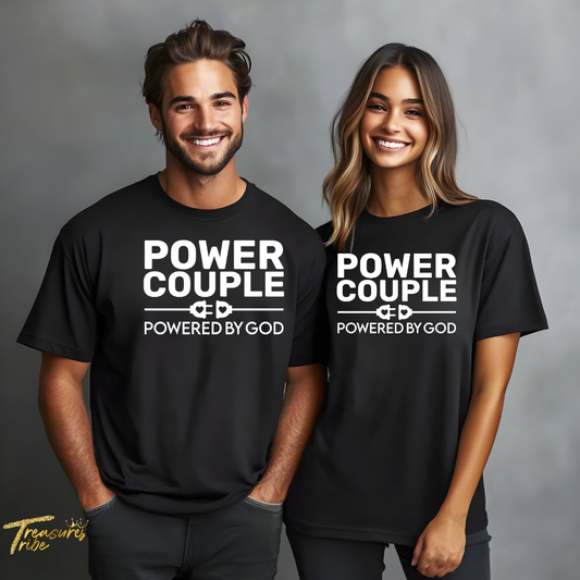 Two people wearing black 'Power Couple Powered by God' t-shirts on a gray background.